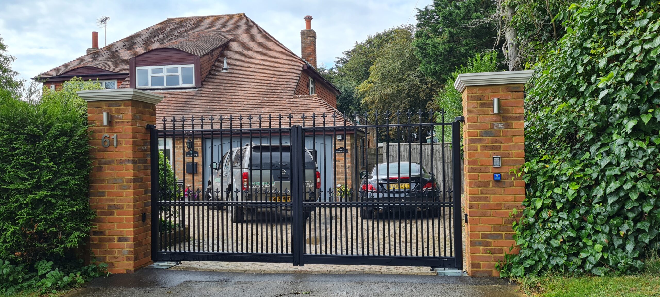 Traditional style aluminium swing gates. The pillars were completed as part of these works with stone caps and lighting